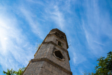 Tall and old abandoned cathedral tower Perast