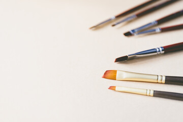 Close up of paint brushes on kraft paper with copy space.