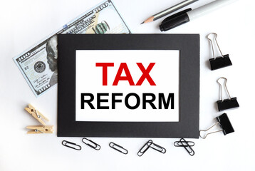 TAX REFORM. text on white paper in black frame on light background