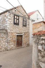 Old abandoned traditional stone house in the town street