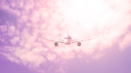 Large plane against the background of a red sky with clouds