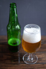 cold beer stands on a wooden table