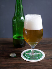 cold beer stands on a wooden table