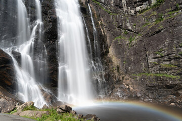 Skjervsfossen waterfall, on the road between Granvin and Voss, Hordaland, Norway. Impressive beautiful win falls plunging 150 metres in a narrow canyon