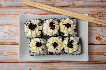 sushi rolls with cheese and black caviar