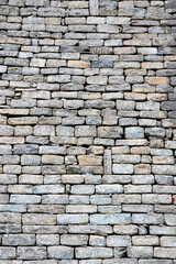 Close-up of stone wall use for construction business and designers. Stone backgrounds textured pattern abstract image. Seamlessly tiling stone wall background texture. A stone wall texture background.