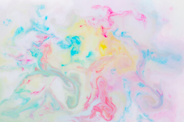 Fluid art. Multicolored background from liquid. Photography of colored spots on liquid. Abstract pattern