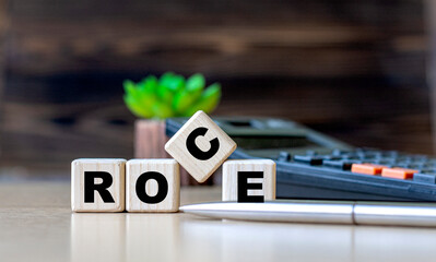 ROCE - the word on the cubes on the background of the calculator and cactus