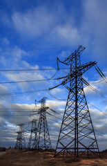  high-voltage  power lines at storm clouds.