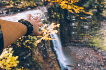 first person view man hands showing waterfall