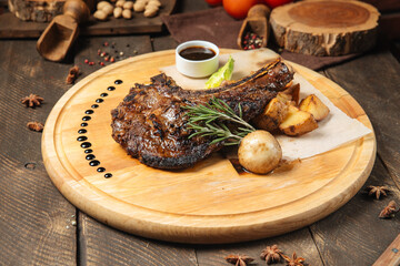 Side view on cowboy beef steak on a wooden board