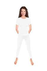 Fit brunette woman wearing white leggings and a shirt, full length portrait isolated in front of white studio background