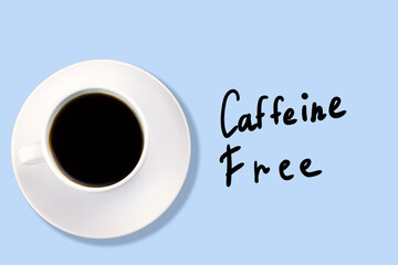 top view white coffee cup on a blue background with inscription caffeine free