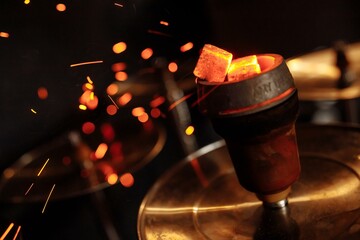 Shisha hookah with red hot coals. Sparks from breathe. Modern hookah with coconut charcoal and shisha smoke - obrazy, fototapety, plakaty