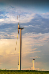 Renewable energy with wind farm turbines and generators in the sunset, beautiful landscape 