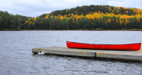 Canoe with beautiful autumn color at Algonquin Provincial Park, Canada