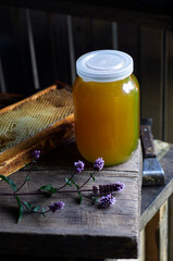 Jar of honey. Honey and honeycombs in the apiary. Beekeeper's workshop. Tools for honey extraction. Apiary. Extraction of honey. Beekeeper's tools. Honey production.