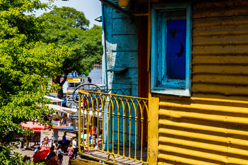 Fototapeta na wymiar Balconies and windows of a colorful tenement house in Caminito, in the La Boca neighborhood