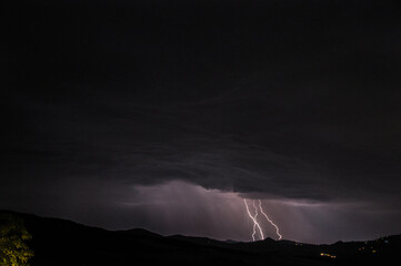 Lightning above the hills in Tuscany, Italy