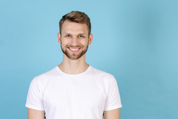 Fototapeta premium Young man standing isolated on blue background