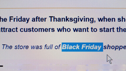 Black Friday is covered in headlines and news sites around the world. Close up view of computer monitor screen. Sales season. Stop movement.