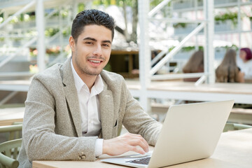 Happy young successful manager or agent in formalwear looking at you with smile