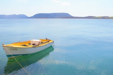Ermioni, Greece, Peleponnese small boat onthe ocean with mountains