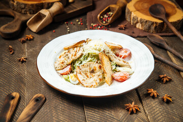 Side view on caesar salad with chicken and iceberg