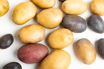 Assorted Color Potatoes On Flat White Surface Table