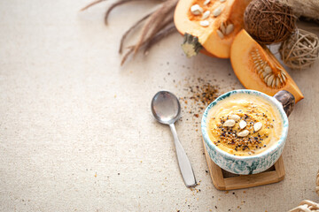 Delicious composition with pumpkin soup, top view.