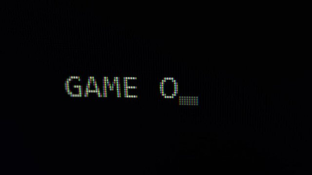 Typing phrase Game over text on black computer screen 4K