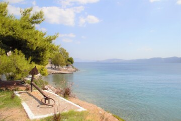 Obraz premium Anchor and coast line, greece