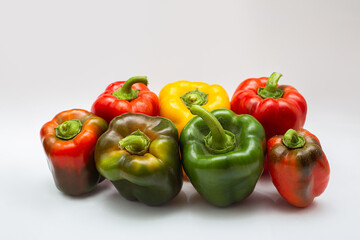 
multicolored peppers on a white background