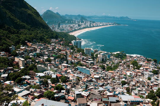 Aerial view of the city of Rio de Janeiro from the top of the Vidigal mountain, Rio de Janeiro, Brazil. Horizon under blue sky. Travel destination exotic culture concept.