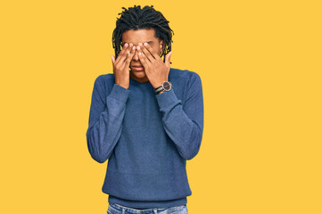 Young african american man wearing casual winter sweater rubbing eyes for fatigue and headache,...
