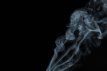 White smoke from incense on a black background