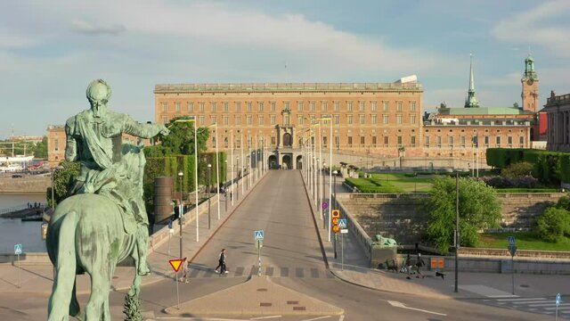 Stockholm palace and statue drone view. People tourists passing by. Norrbro