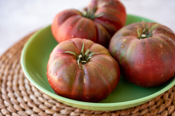 New harvest of big raddish-purple heirloom tomatoes Black Crimea