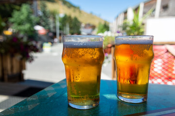 French cold beer in misted glasses served on outdoor terrace in small Alpine village in France