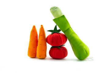 Toy vegetables from fleece isolated on White background. Soft toys tomatoes, carrots, Leek. Alkaline diet. Healthy food.