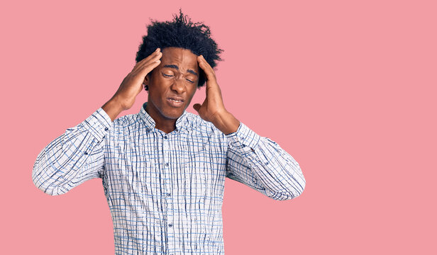 Handsome african american man with afro hair wearing casual clothes suffering from headache desperate and stressed because pain and migraine. hands on head.