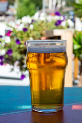 French cold beer in misted glass served on outdoor terrace in small Alpine village in France