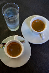 Drinking of strong black espresso coffee on outdoor terrace in cafe