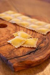 Handmade uncooked fresh ravioli with four cheeses filling, tasty vegetarian food