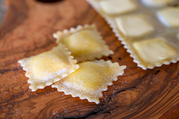 Handmade uncooked fresh ravioli with four cheeses filling, tasty vegetarian food