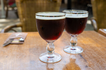 Glasses with cold dark strong Belgian beer served outdoor