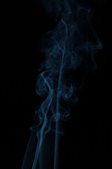 blue smoke from incense on a black background