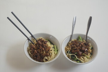 Chicken noodles with green mustard greens. served in a bowl. typical asian food