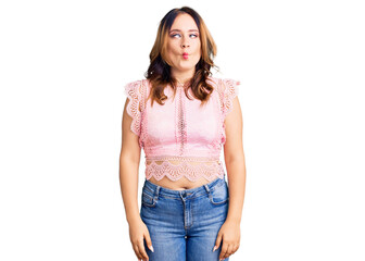 Obraz premium Young beautiful caucasian woman wearing casual clothes making fish face with lips, crazy and comical gesture. funny expression.