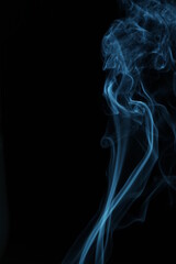 blue smoke from incense on a black background